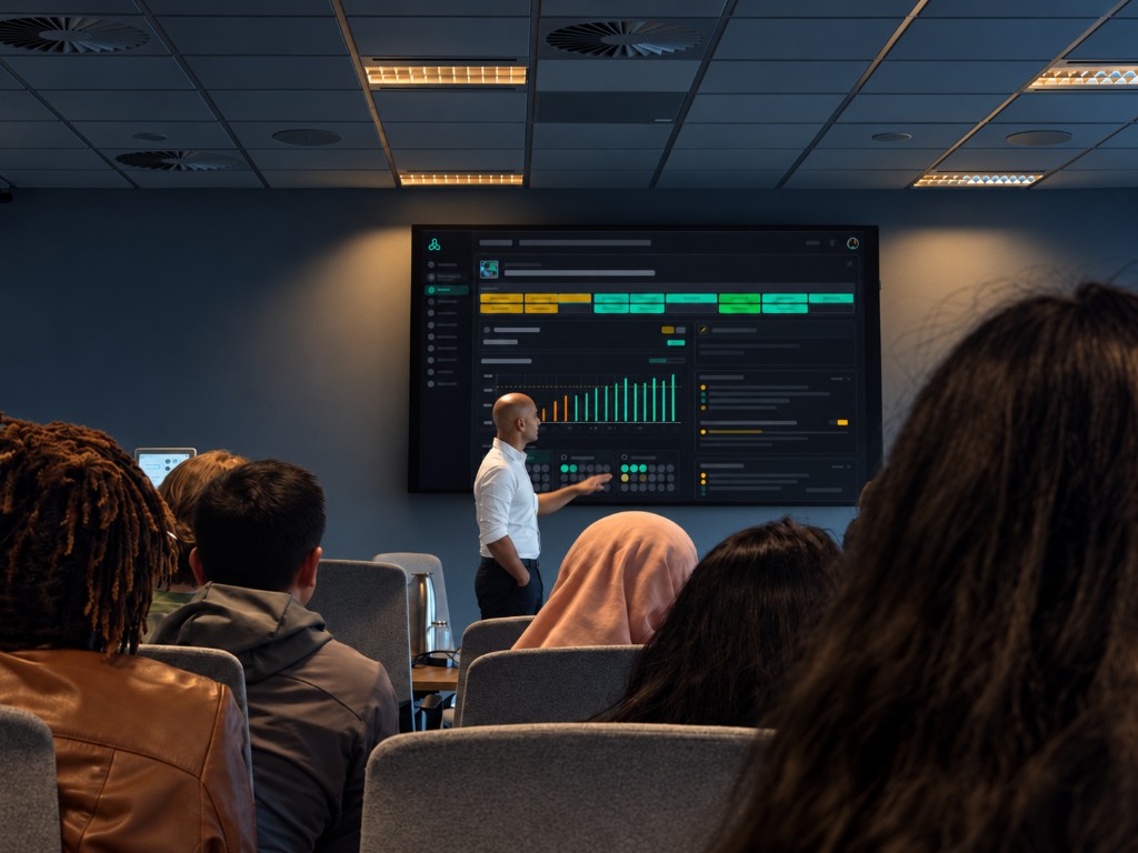 A facilitator presenting a Polynize capability dashboard to a group